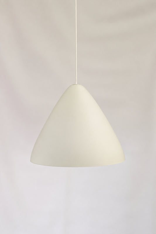 A modern, minimalist cone-shaped pendant light in a matte off-white finish, suspended by a thin cord against a draped white fabric background.