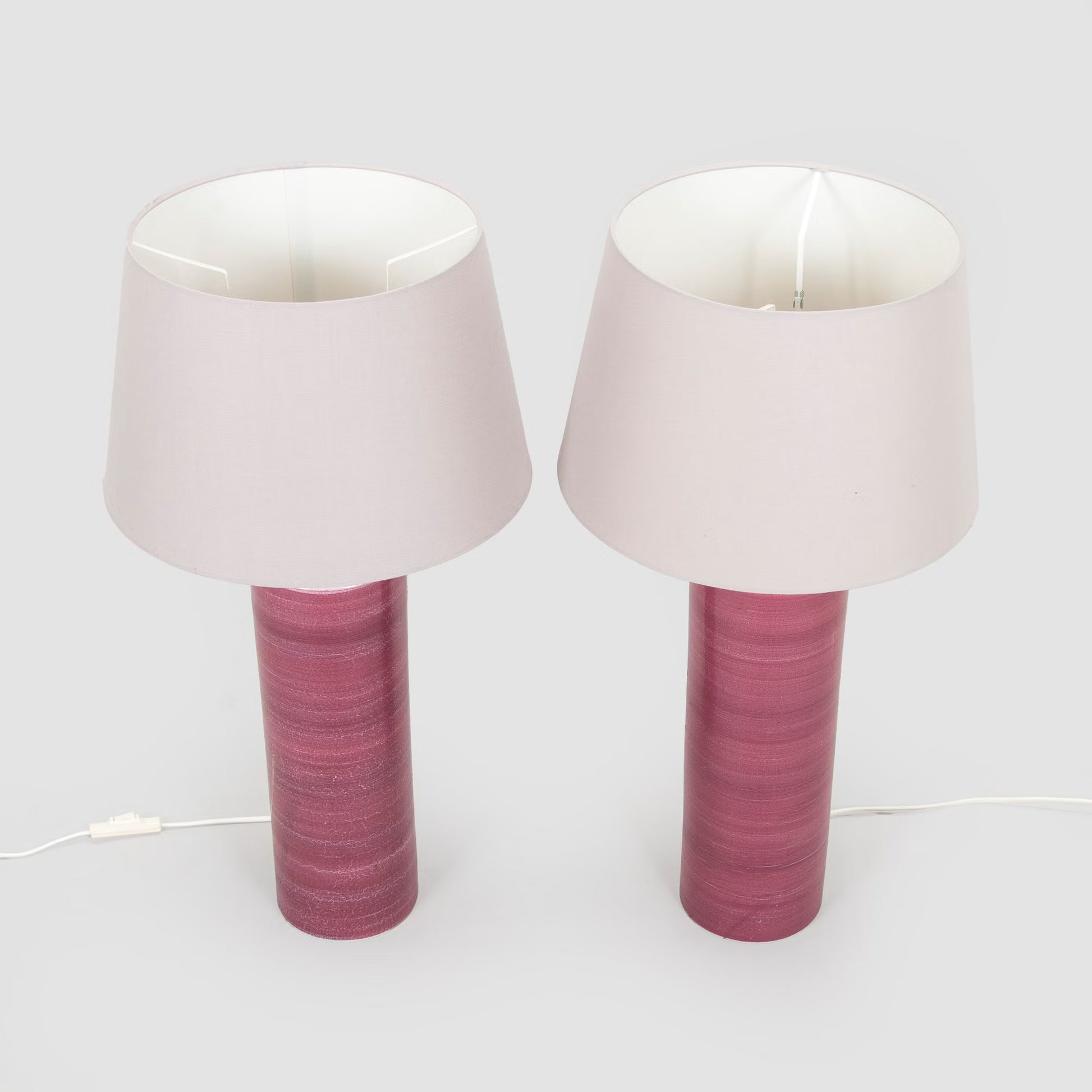 2 pink ceramic lamps with light gray lampshades
