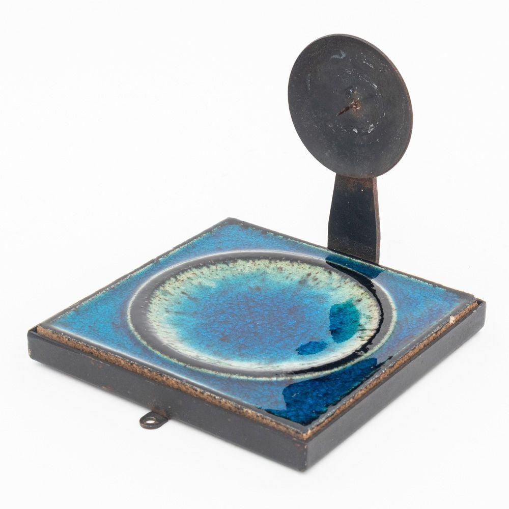 Decorative ceramic plate with a blue glaze on a white background