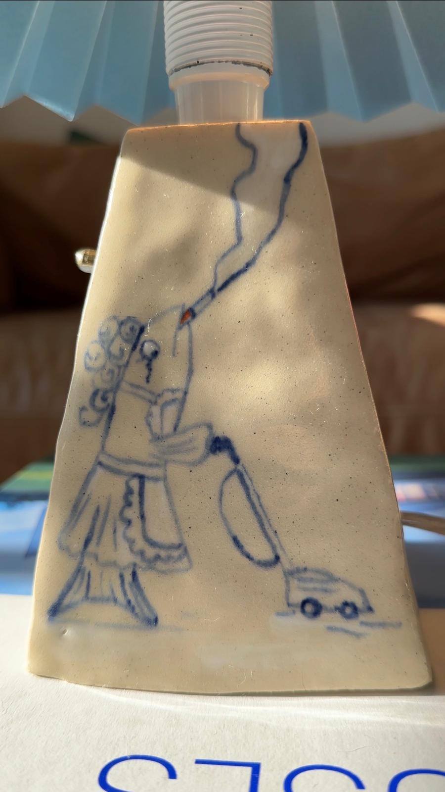 close-up view of artist made lamp showing a female fish vacuuming