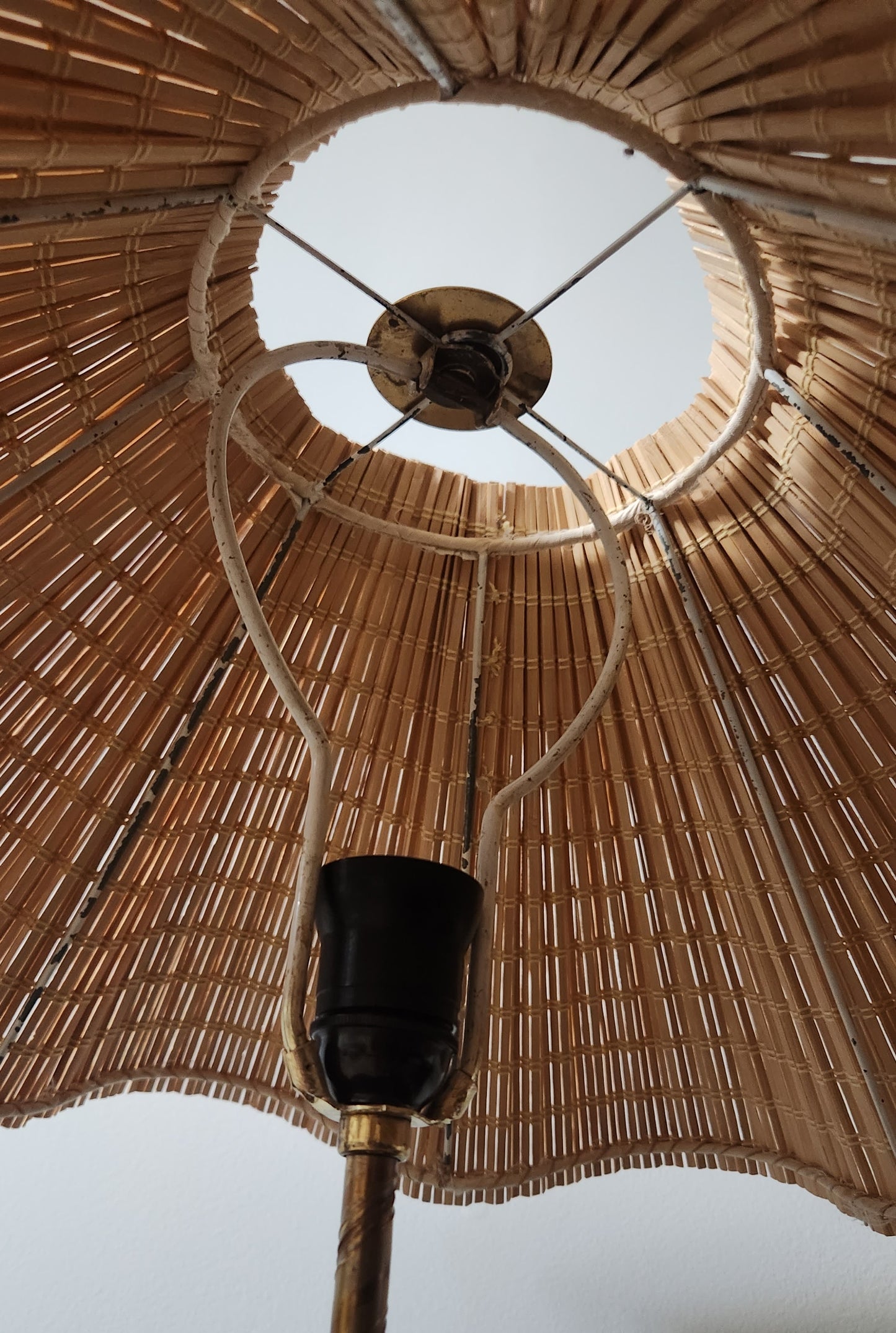 inside view of lampshade made from slats of wood tied together with linen string