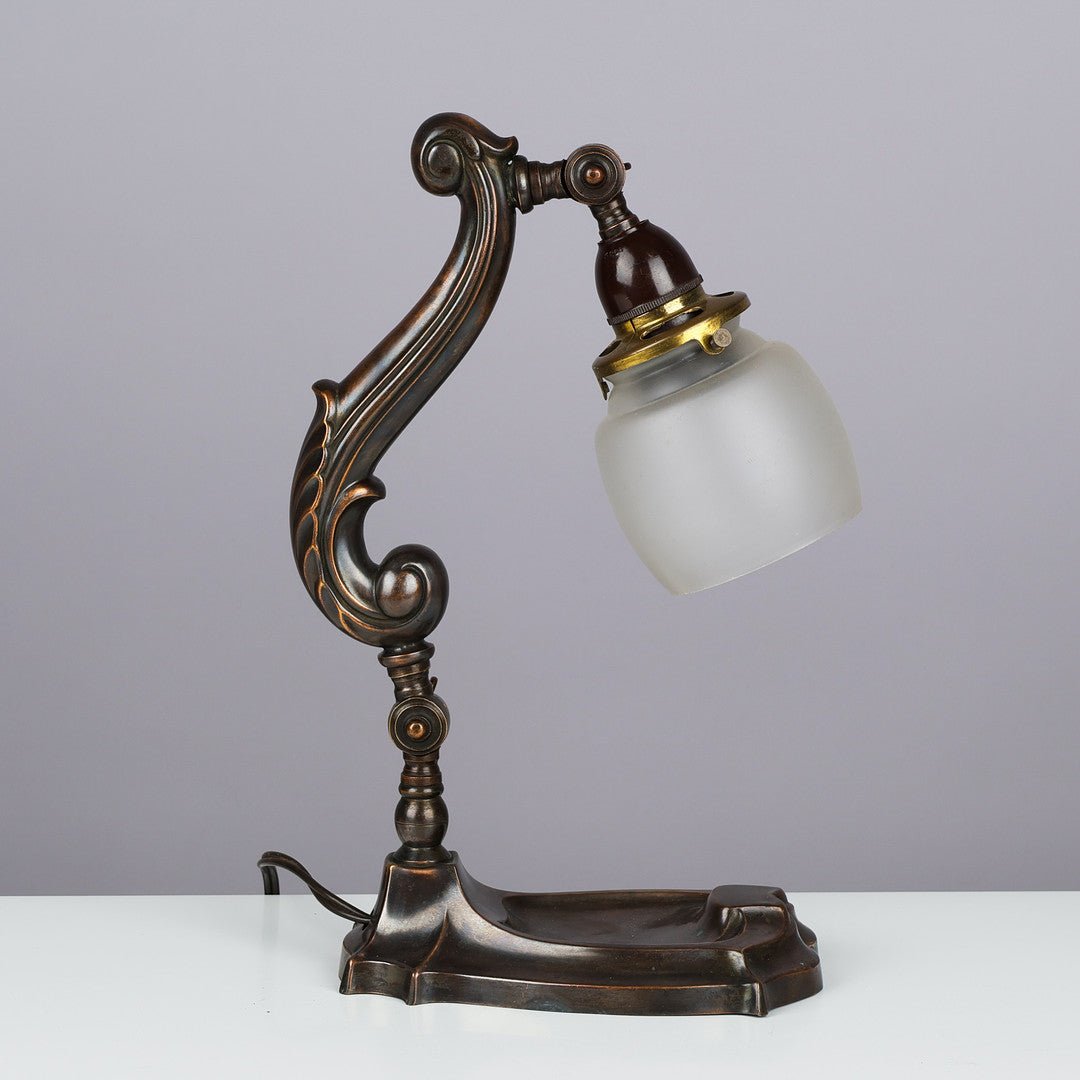 Vintage-style desk lamp with intricate design on a plain background