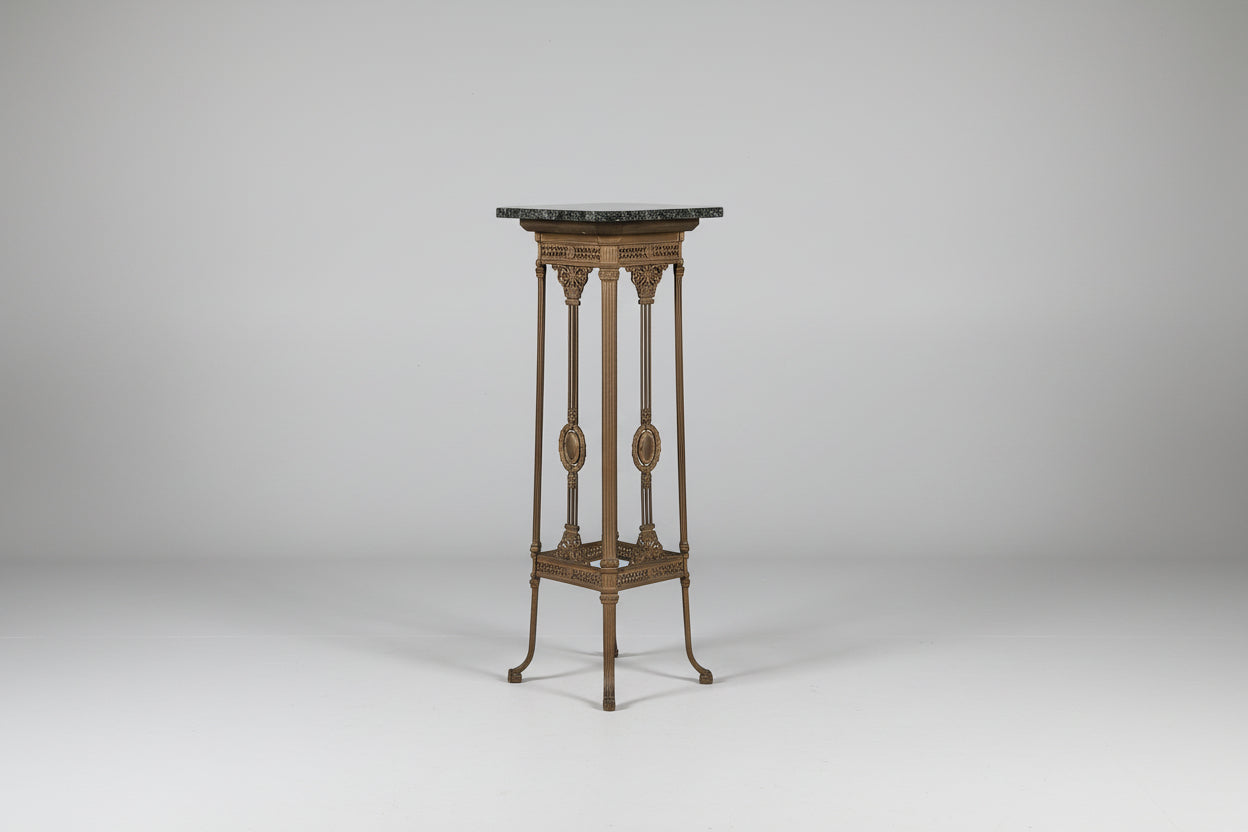 Decorative stand with marble top on a plain background