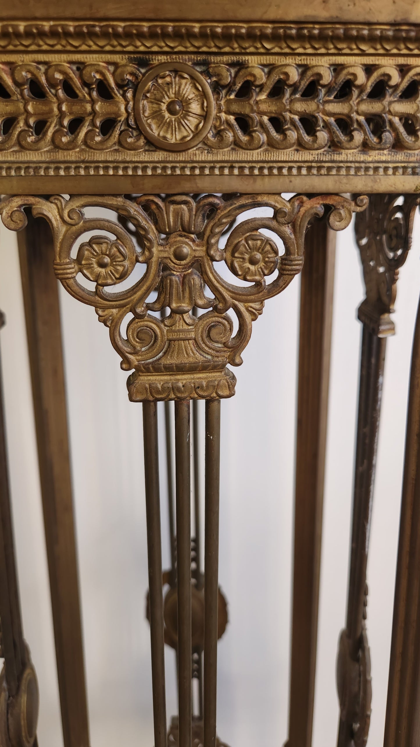 Decorative gold stand with intricate carvings on a white background