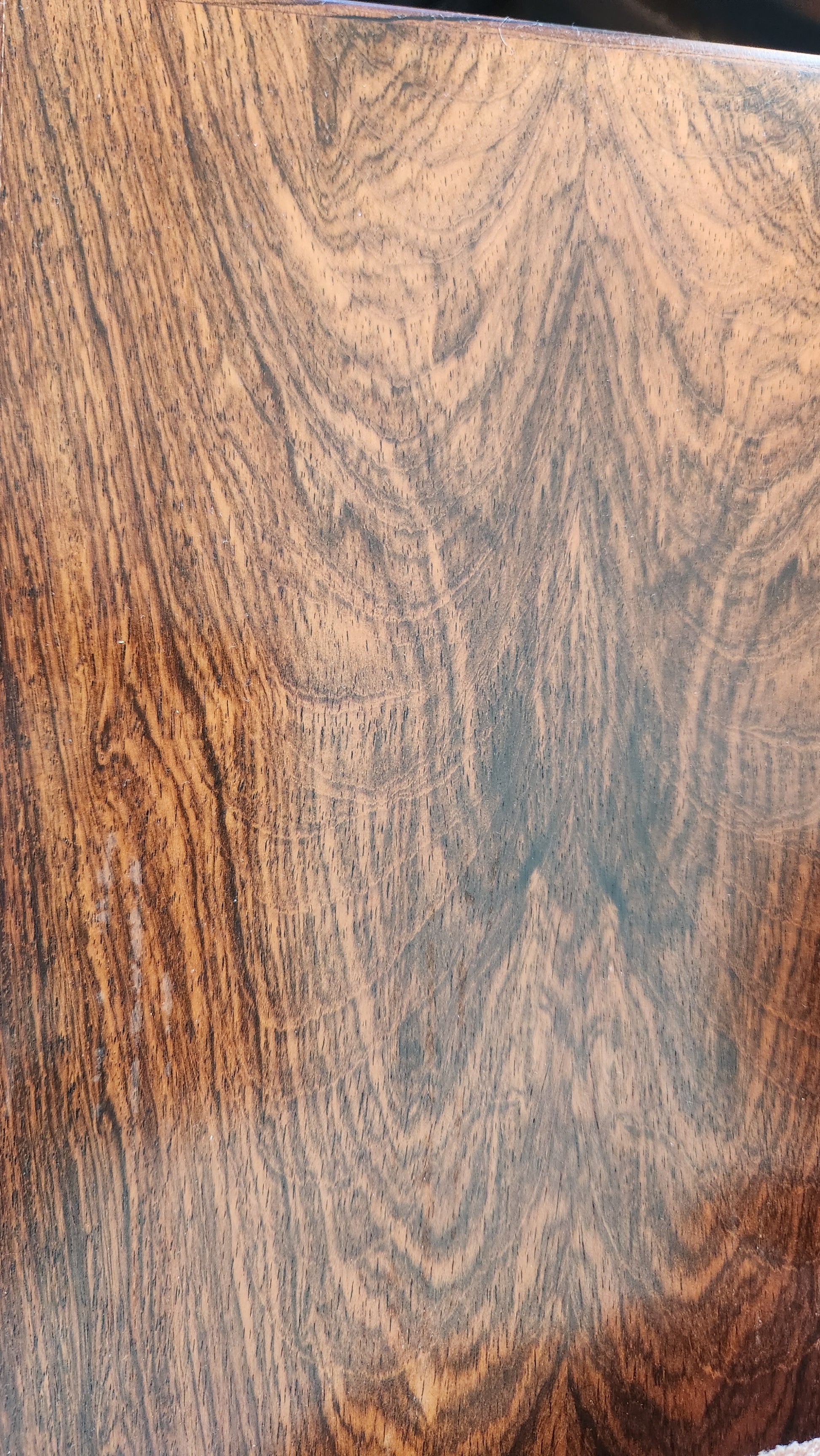Close-up of a wooden surface with a wavy grain pattern