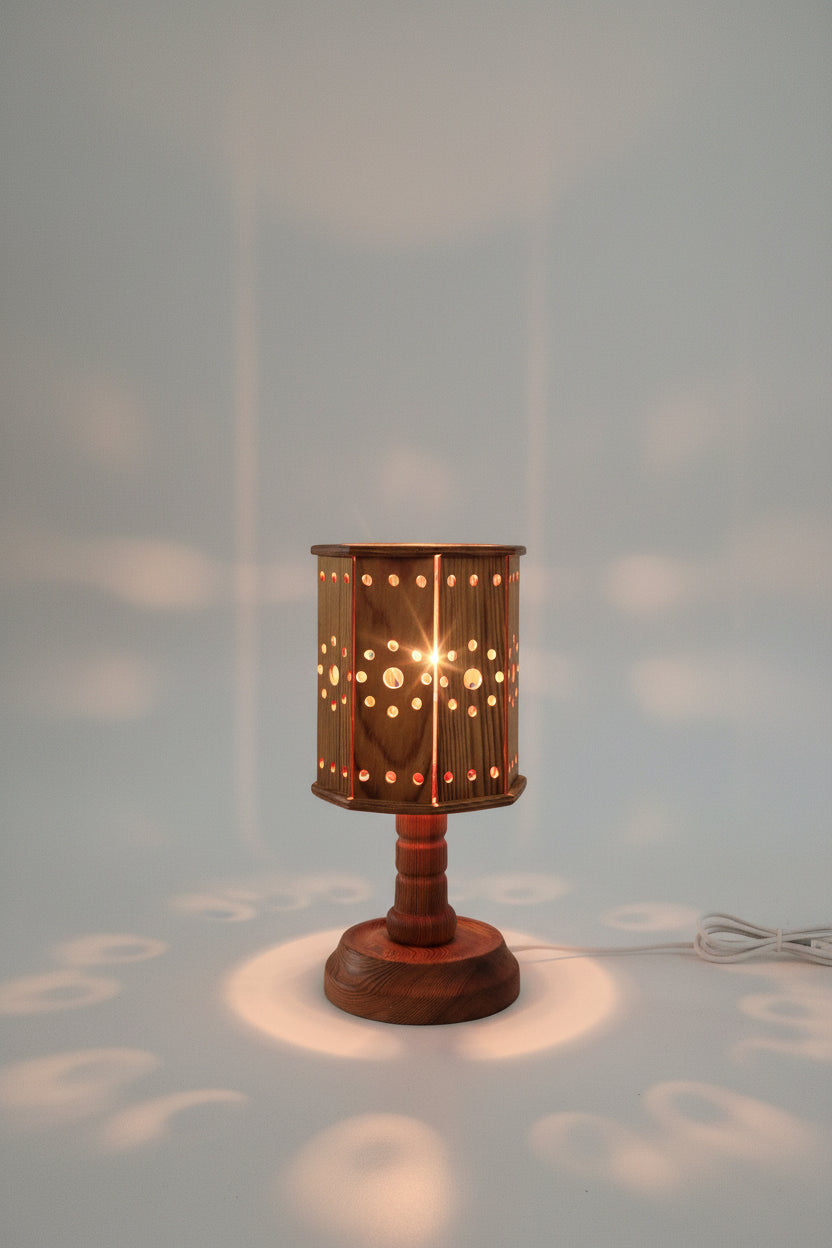 Wooden lamp with a textured shade on a white surface