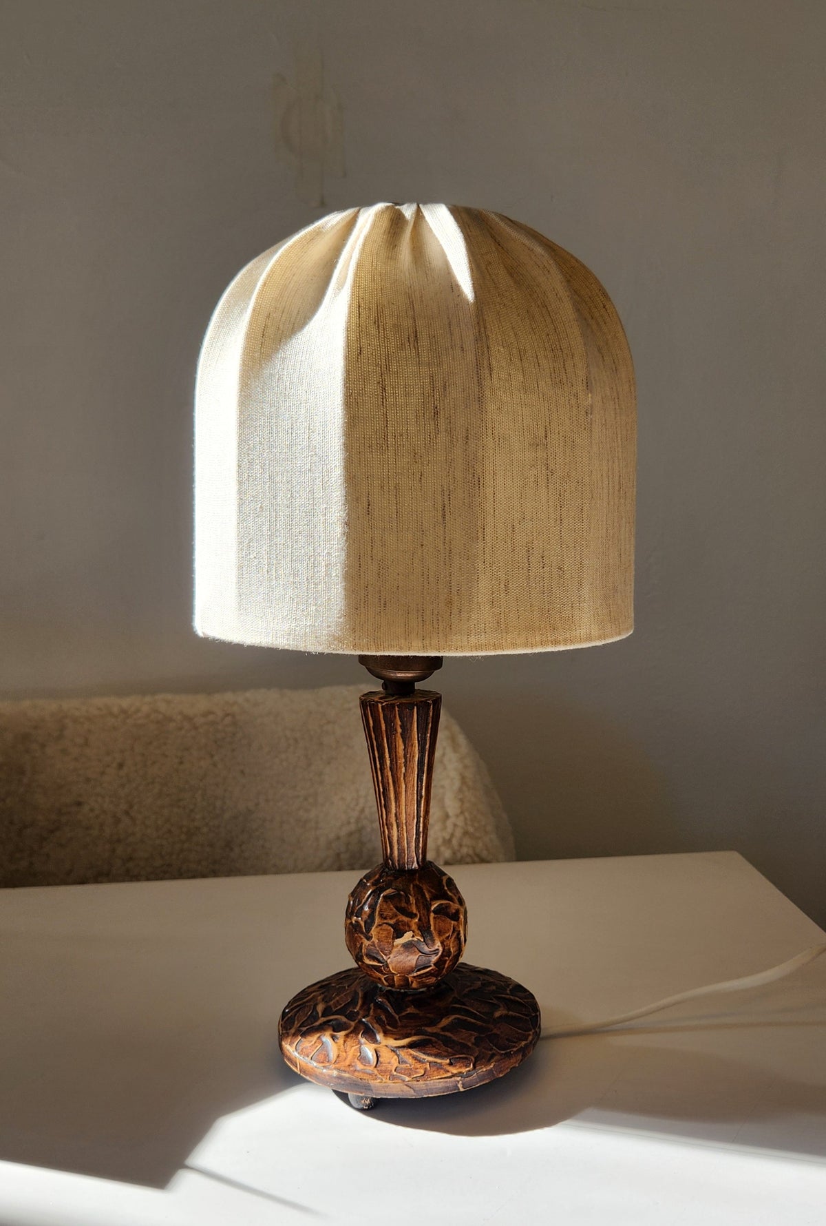 vintage wooden table lamp with carved base and stem, topped with a mushroom lampshade