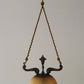pendant lamp with decorative brass frame and sepia colored glass globe
